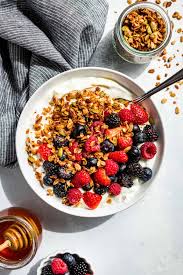 plain greek yogurt wit hgranola and fresh berries. Healthy carbs to eat  